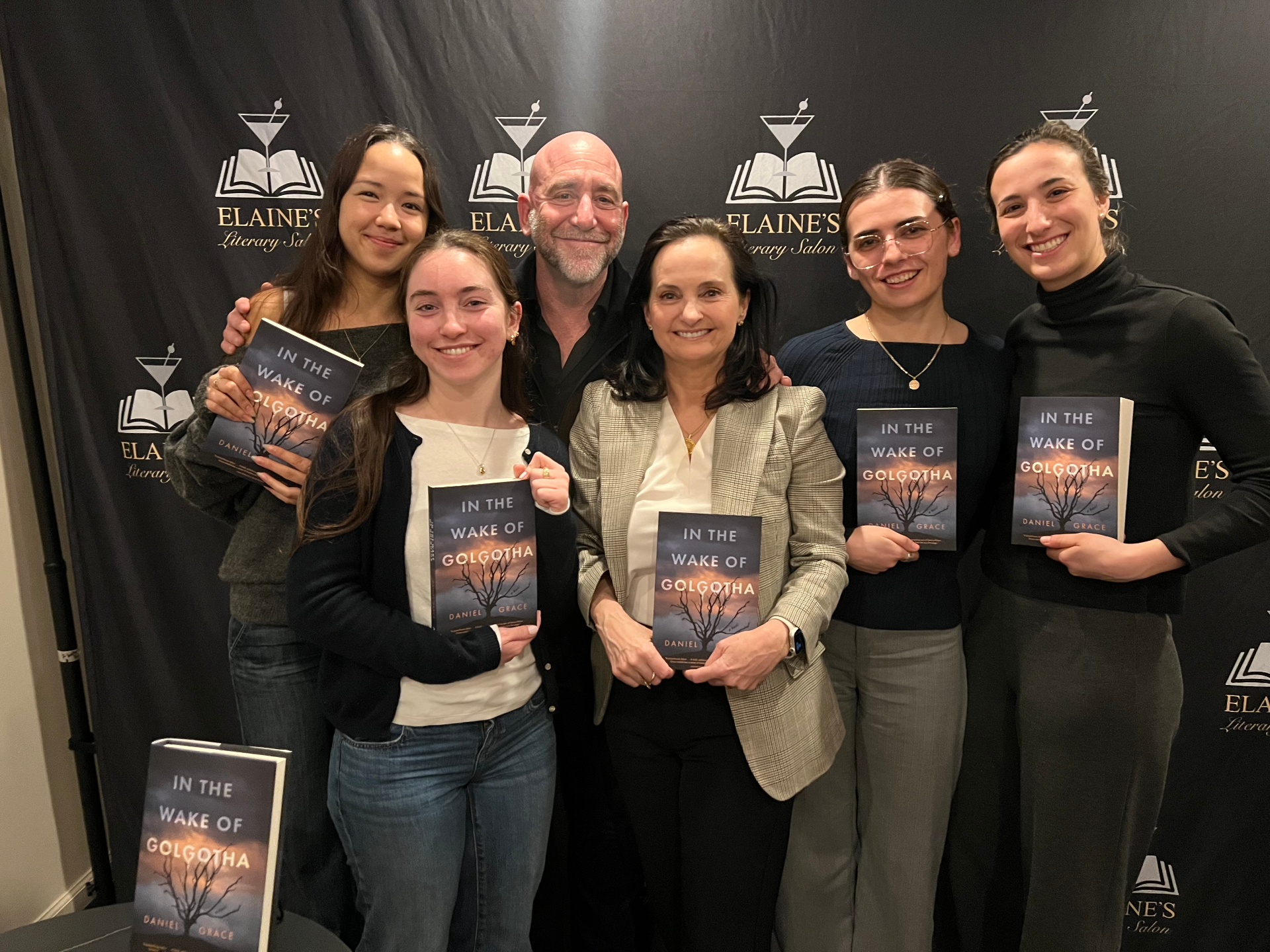 Daniel Grace with readers holding In the Wake of Golgotha at Elaine's Literary Salon