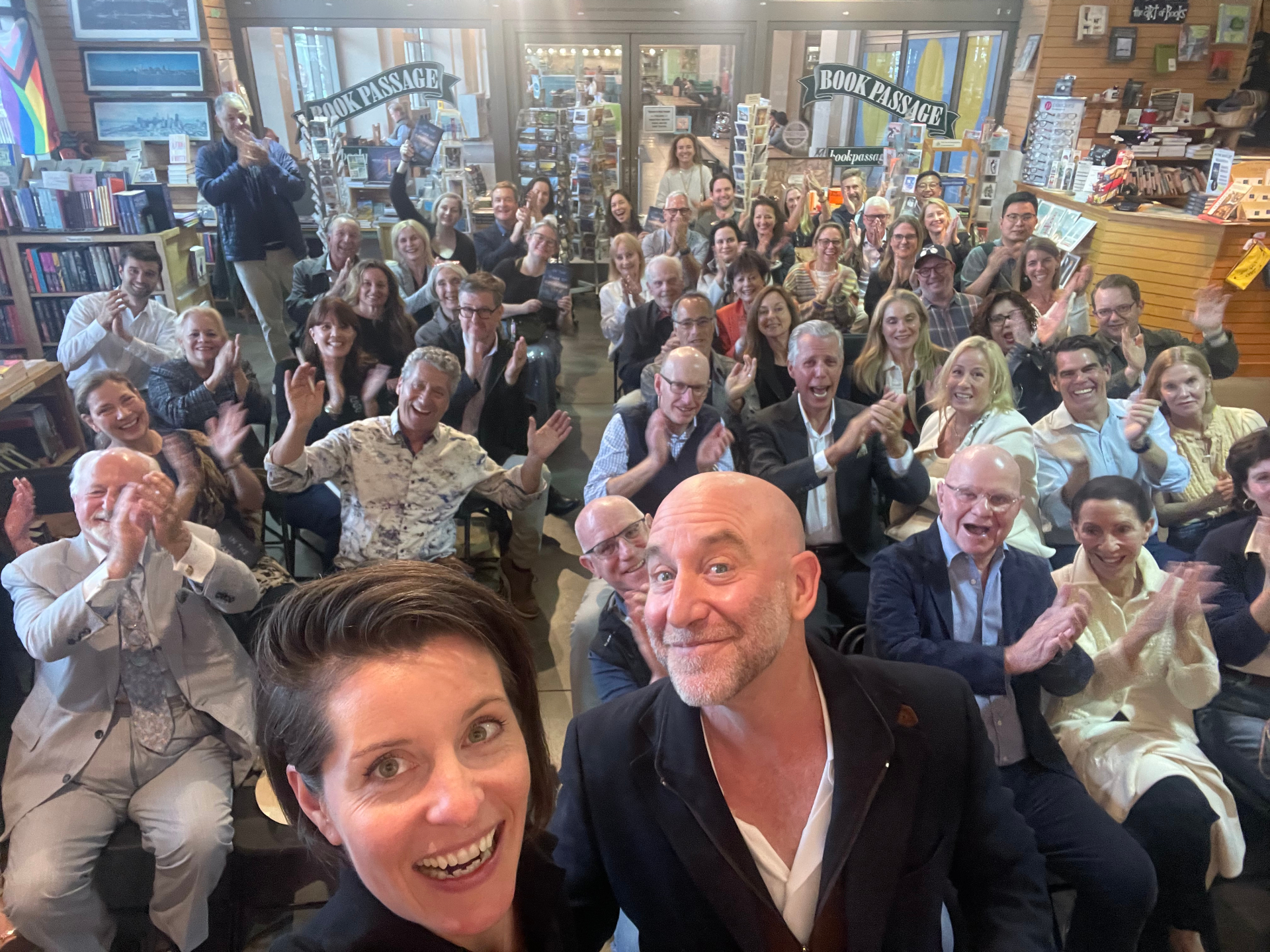 Standing-room crowd applauding at Book Passage event